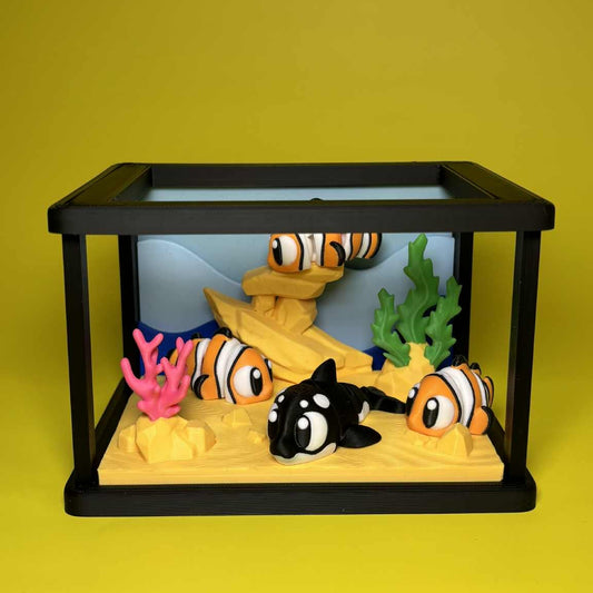 Model aquarium with fish and coral on a yellow background